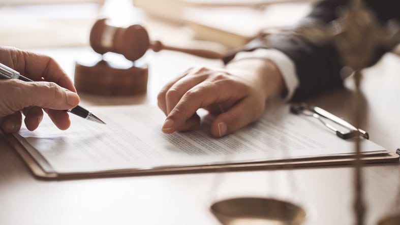 two people looking over a will and inheritance document.